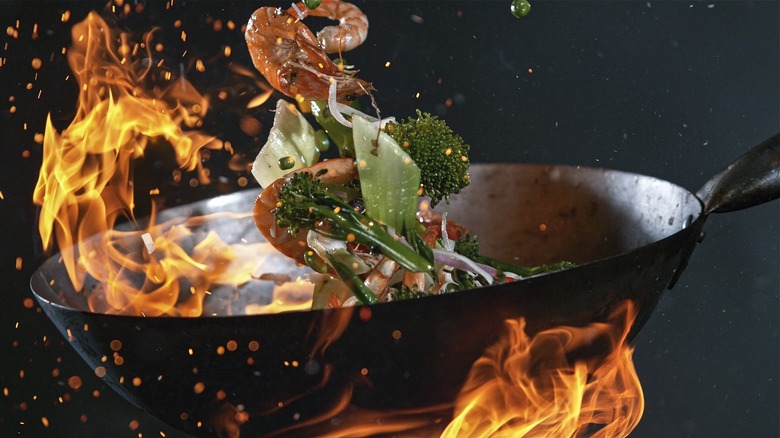 Shrimp and broccoli tossed in a wok