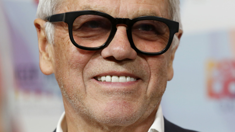 Wolfgang Puck smiling and wearing glasses