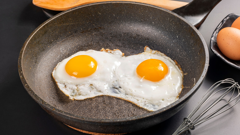 Two fried eggs in a pan