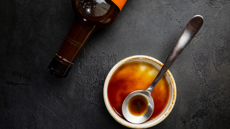 A bowl and bottle of Worcestershire sauce