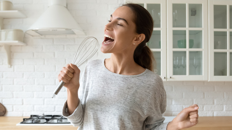 woman singing in kitchen