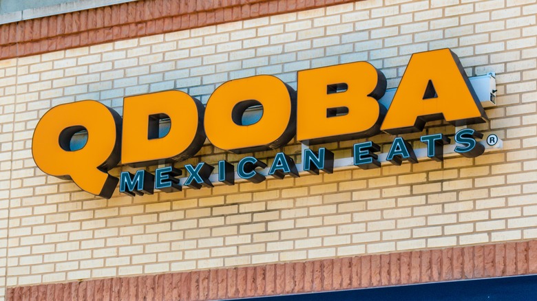 Qdoba sign on brick wall