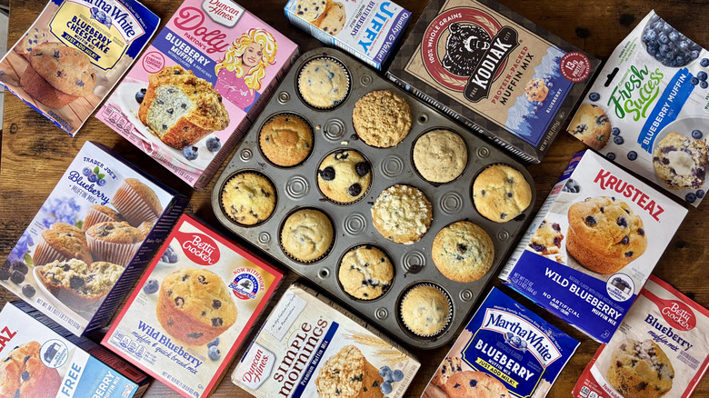 Various boxed muffin mixes around muffins in tray