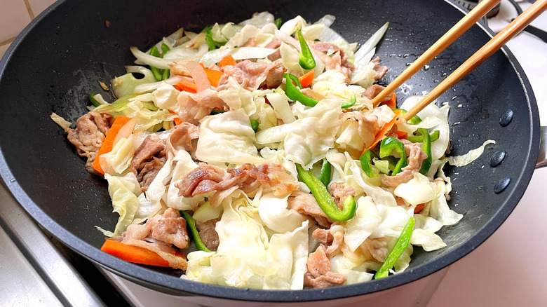 Stir-fry vegetables in a pan