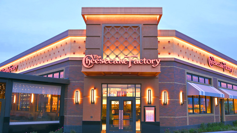 The exterior of The Cheesecake Factory restaurant at dusk
