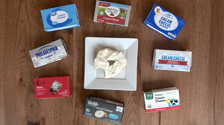 Bagel with cream cheese surrounded by cream cheese boxes