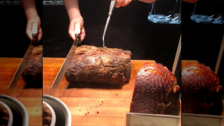 Chef slicing prime rib on cutting board in Buffalo Bill's Irma Hotel.