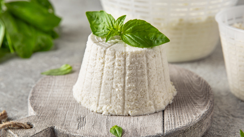 Round of ricotta cheese with leaf sprig