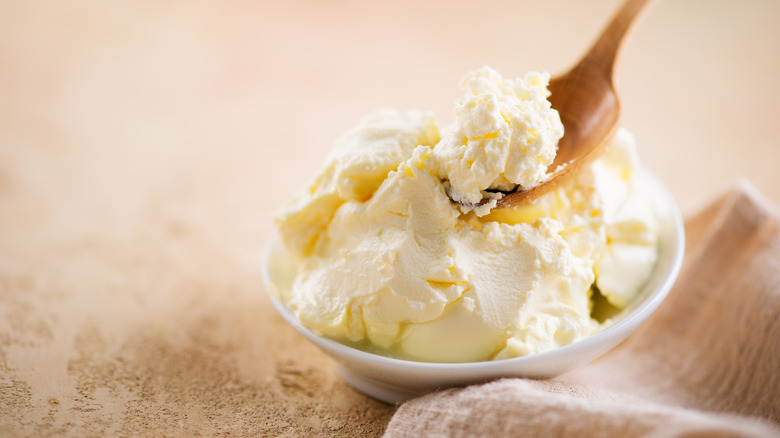 Mascarpone cheese on wooden spoon