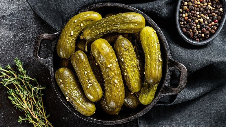 White bowl of pickles with fork