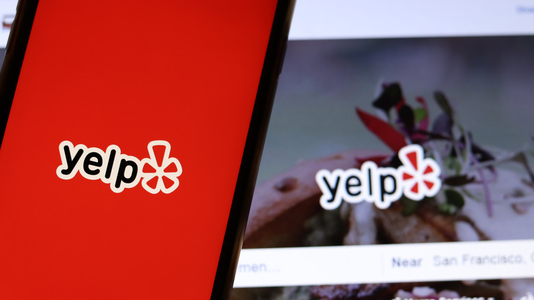 Yelp icon on phone and laptop screen