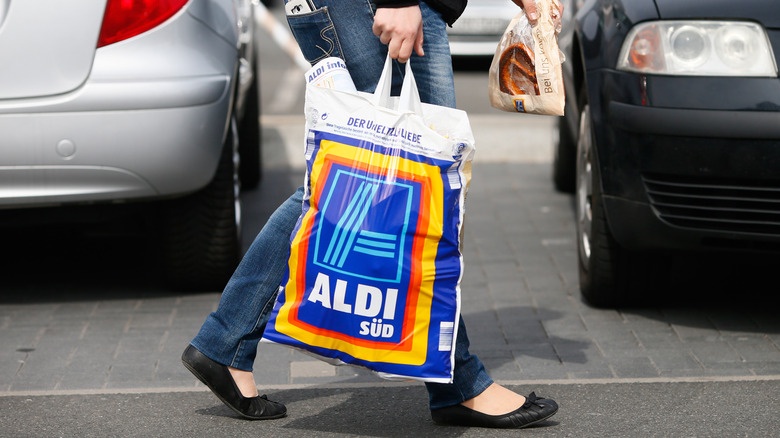 Shopper carrying Aldi bag