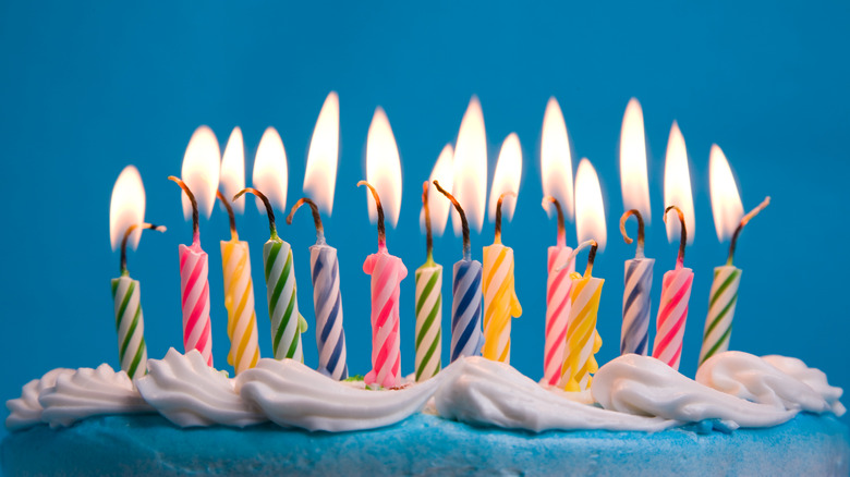 Lit candles on birthday cake