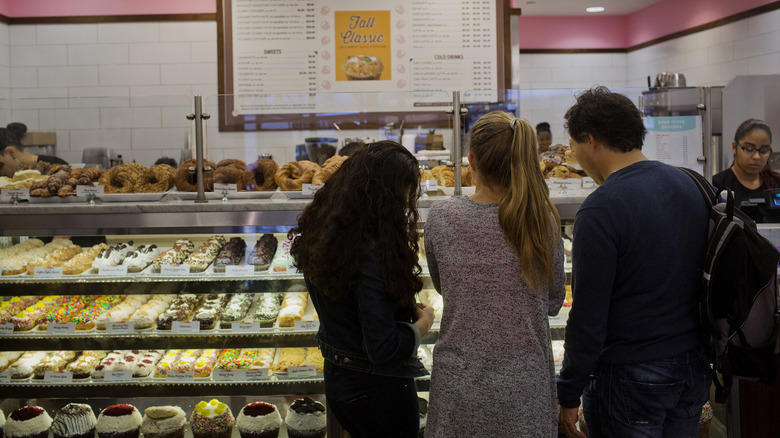 people ordering cupcakes from bakery