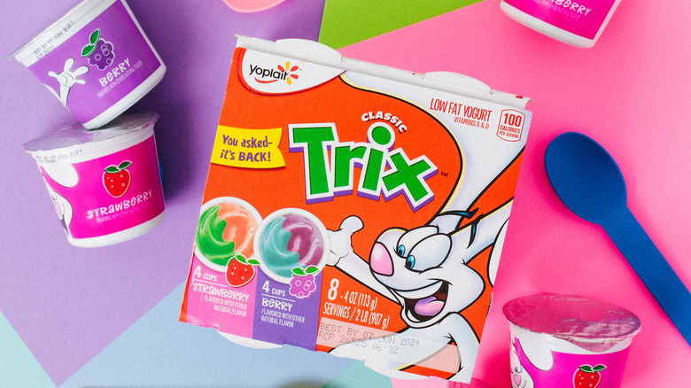 Box of Trix Yogurt next to colorful spoons