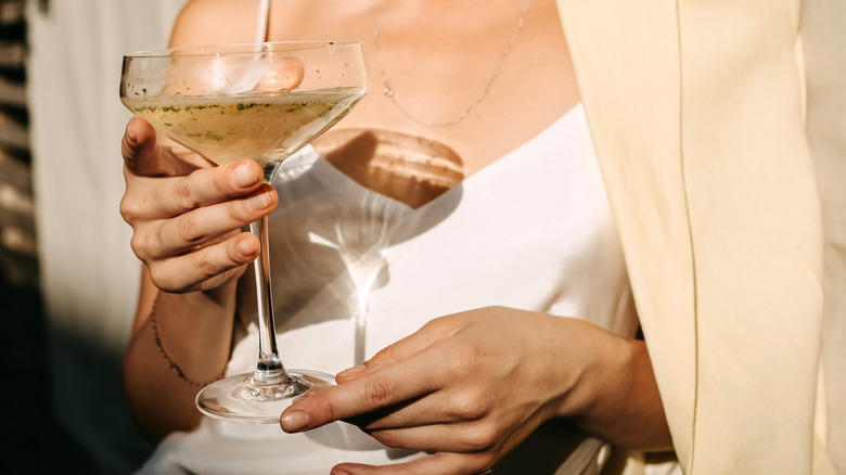 woman holding cocktail