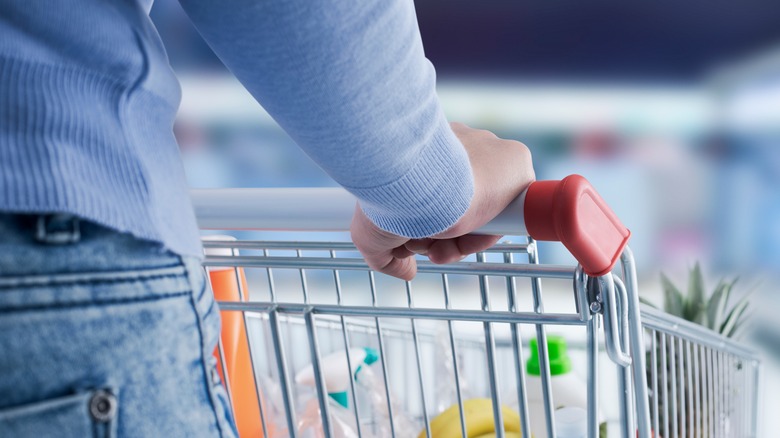 Woman grocery shopping with cart