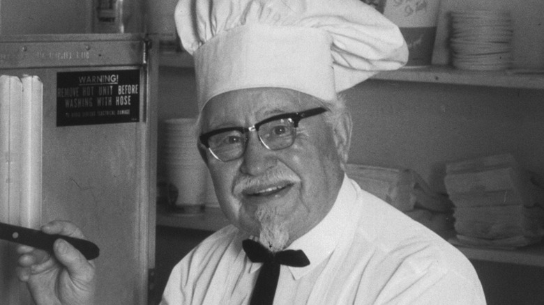 Colonel Sanders wearing chef's hat