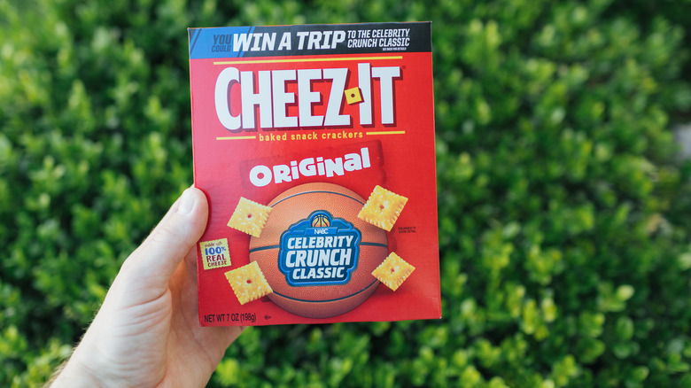 Close-up of hand holding a box of Cheez Its