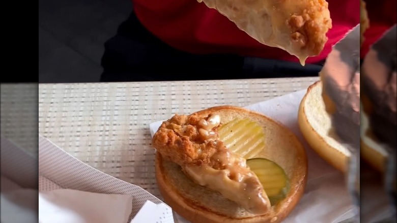 Person making a Chick-fil-A sandwich with Chick-n-Strips