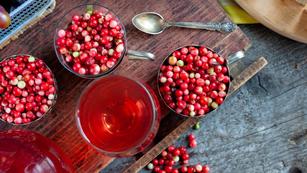 Raw lingonberries and glass of lingonberry juice