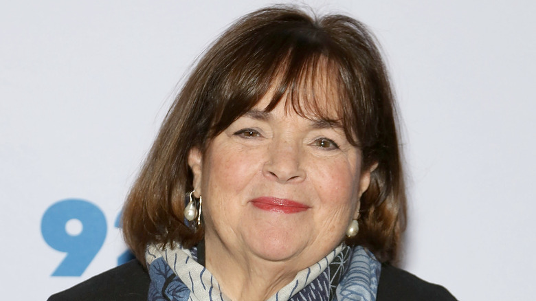 Close up of Ina Garten wearing pearl earings and a blue, black and white scarf