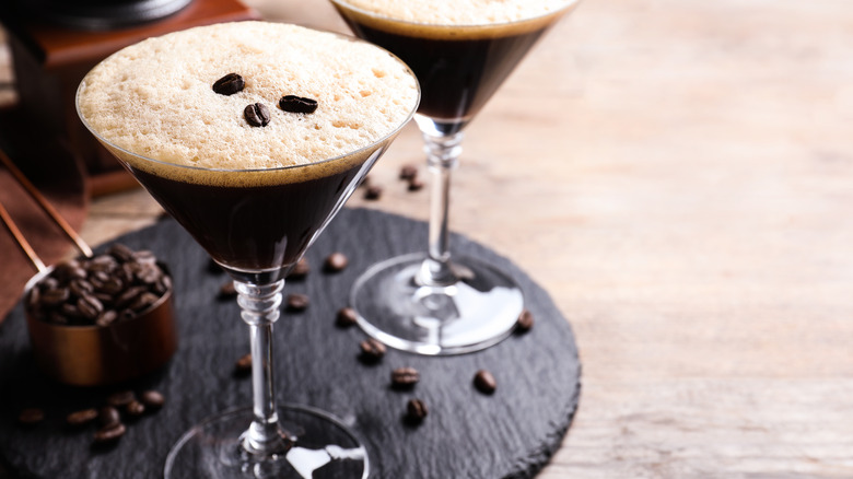 Espresso martini surrounded by beans