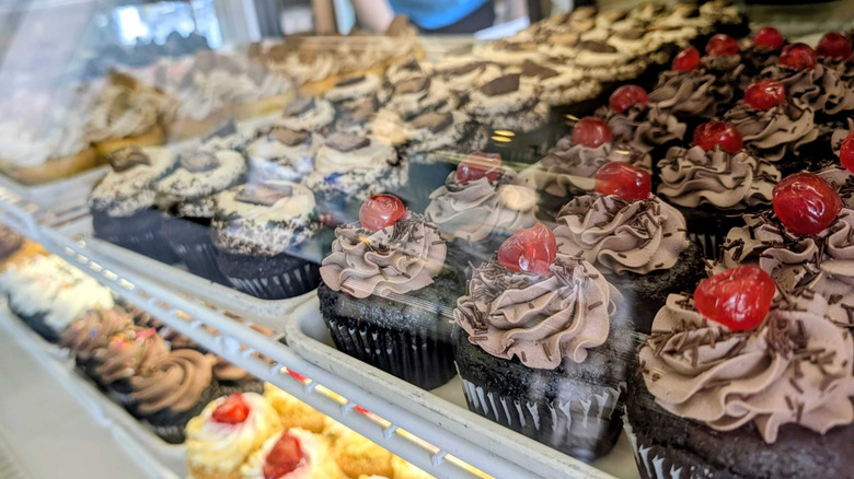 Cupcakes in display case inside Bing's Bakery.