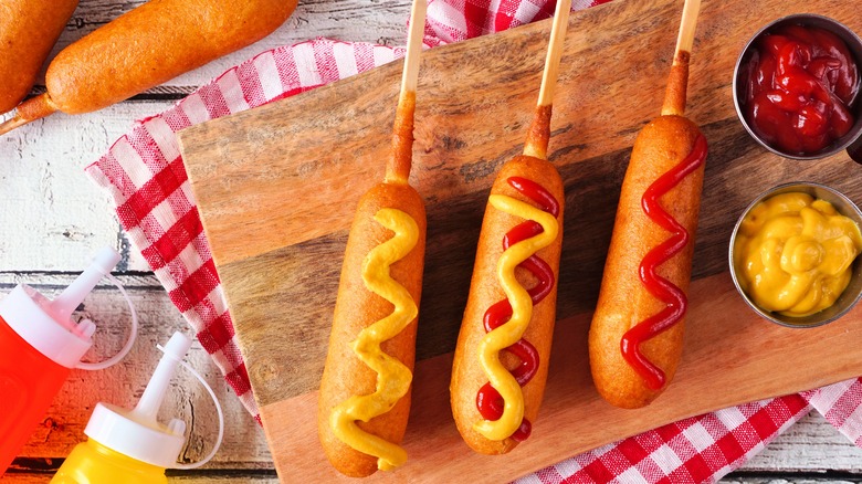 Corn dogs with mustard and ketchup