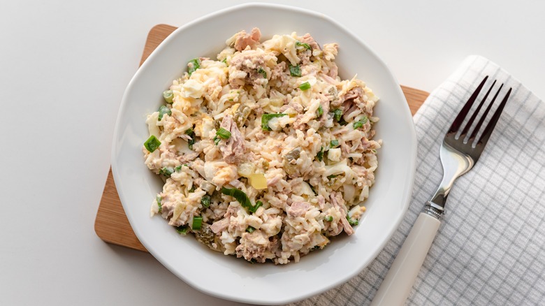 plate of tuna and egg salad with napkin and fork