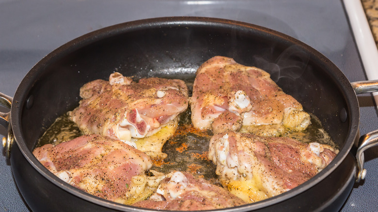 Chicken thighs skin-side down
