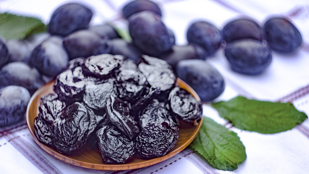 prunes and plums on a checked tablecloth