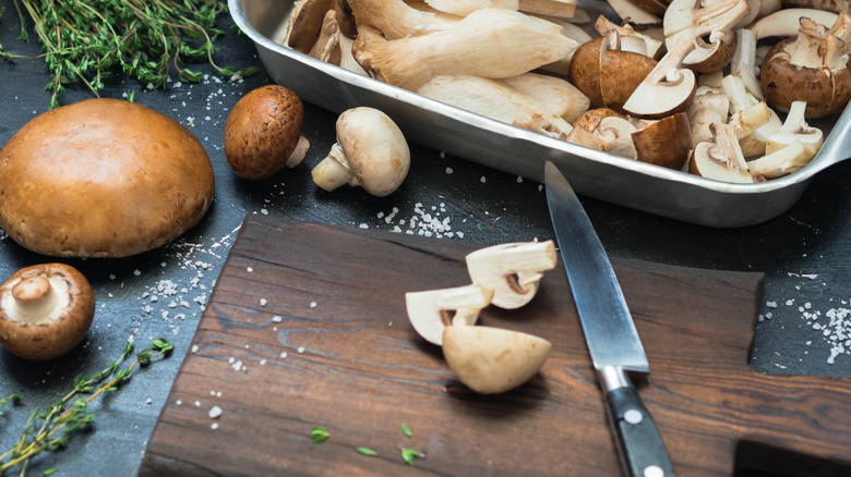 mushroom varieties in baking dish and wooden cutting board