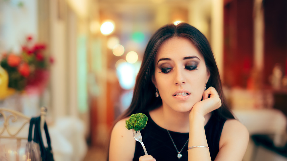 Woman at party with broccoli