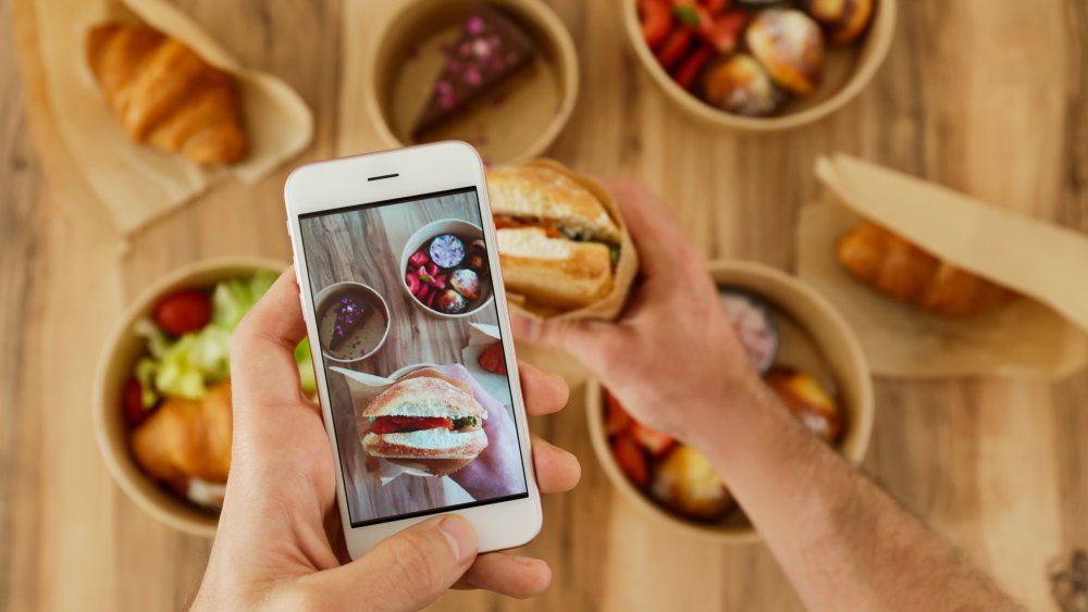 A man taking pictures of food