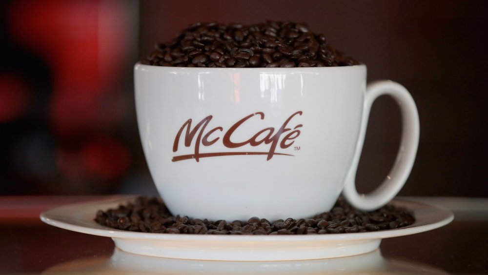 A McCafe cup full of coffee beans