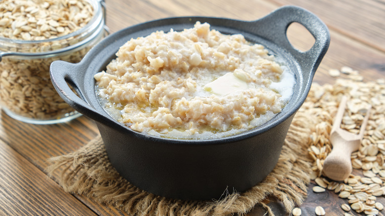 Cooked oatmeal alongside raw oats