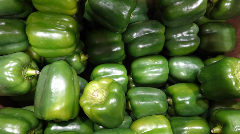Green peppers piled on top of each other