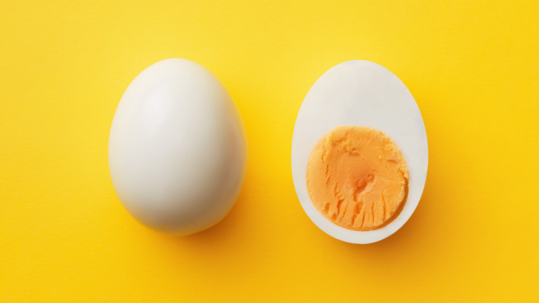 Hard-boiled egg on yellow background