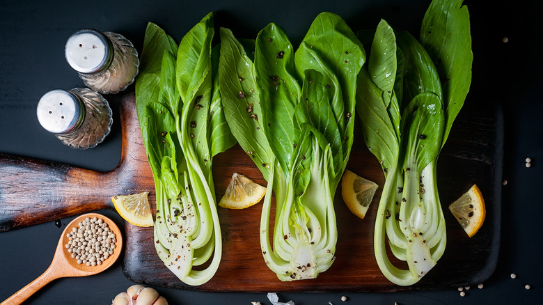 Hearts of romaine on wooden board with seasonings