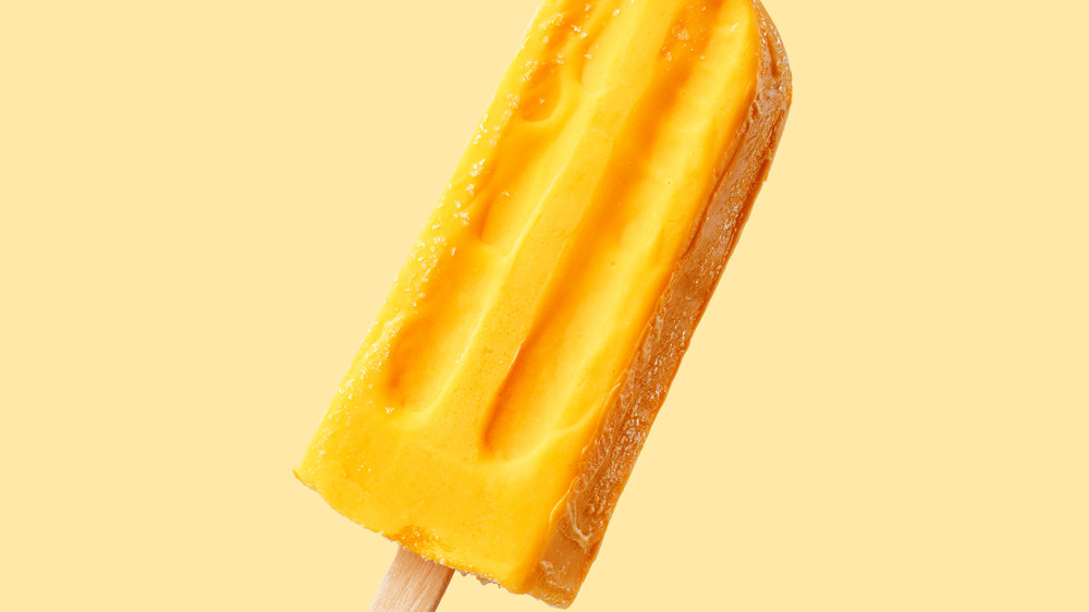 Fruit ice pop against a yellow background