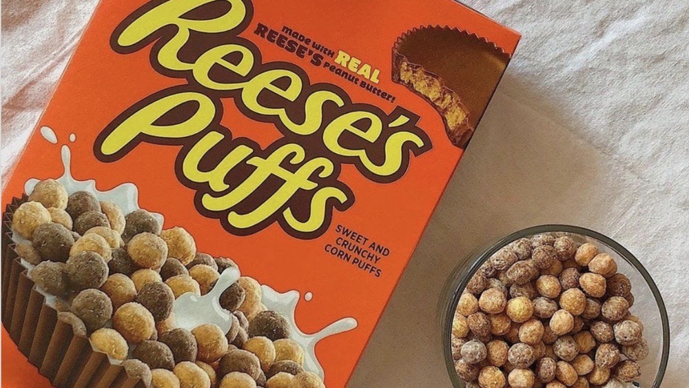 Reese's Puffs box alongside bowl filled with cereal
