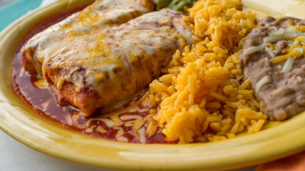 Yellow plate with chimichangas, rice and beans