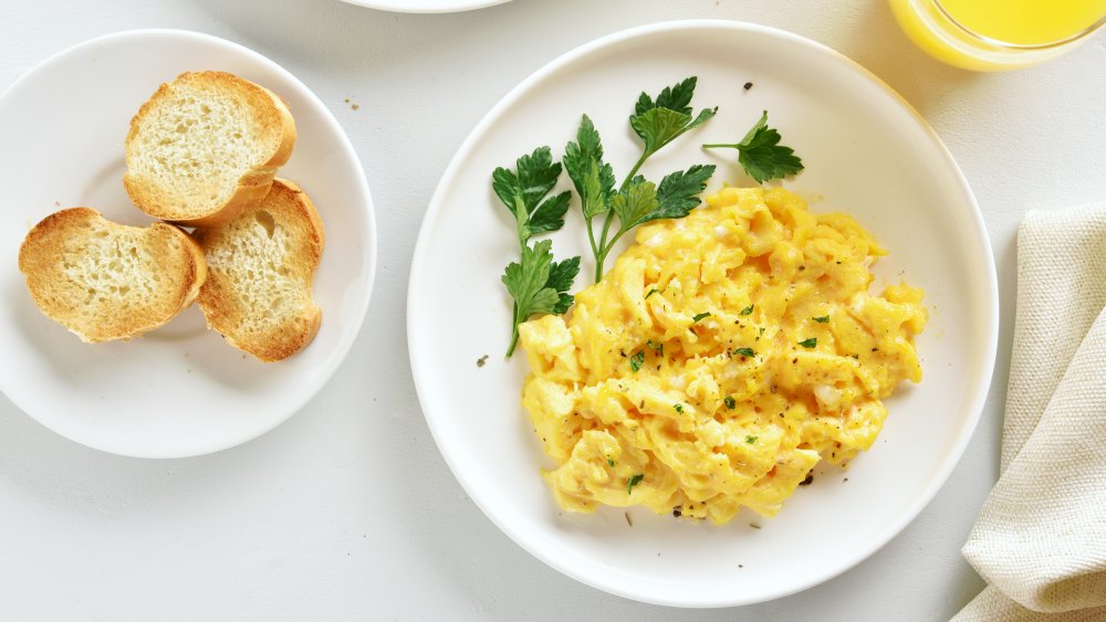 scrambled eggs, toast, and orange juice breakfast