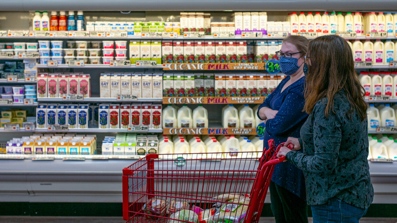 two women shopping in dairy aisle at Trader Joe's