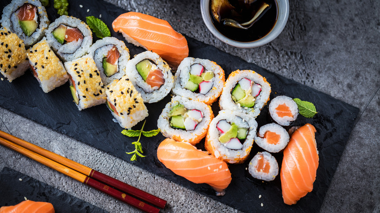 A slate of nigiri sushi and maki rolls 