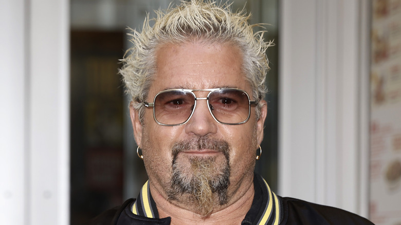 Guy Fieri in sunglasses, smiling