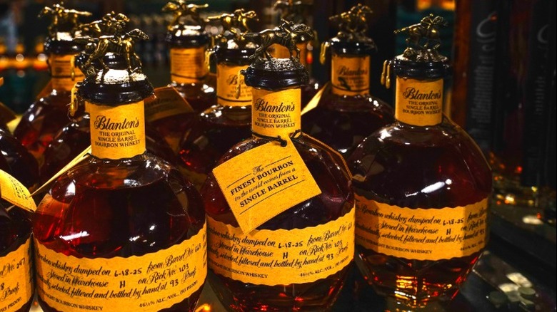 Bottles of Blanton's bourbon lined up on a shelf