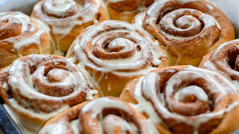 fresh frosted cinnamon rolls in pan