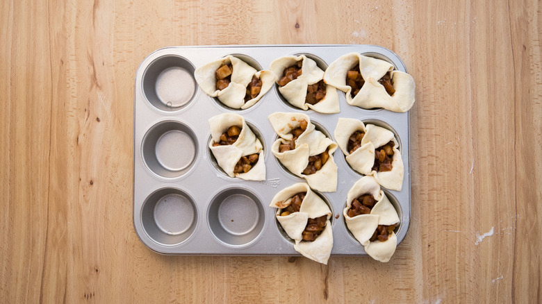 partially made croissants in muffin tin